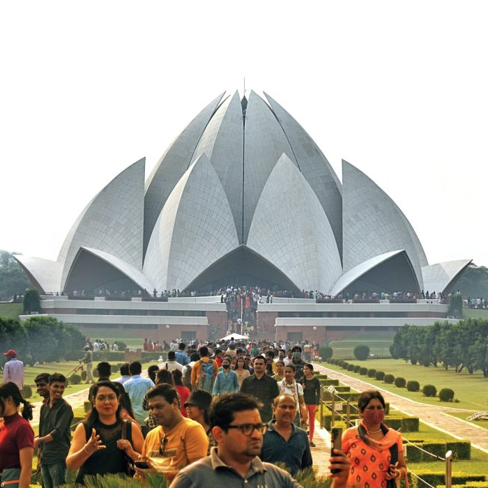 Delhi 5 a large crowd of people in front of a large building with Lotus Temple in the background